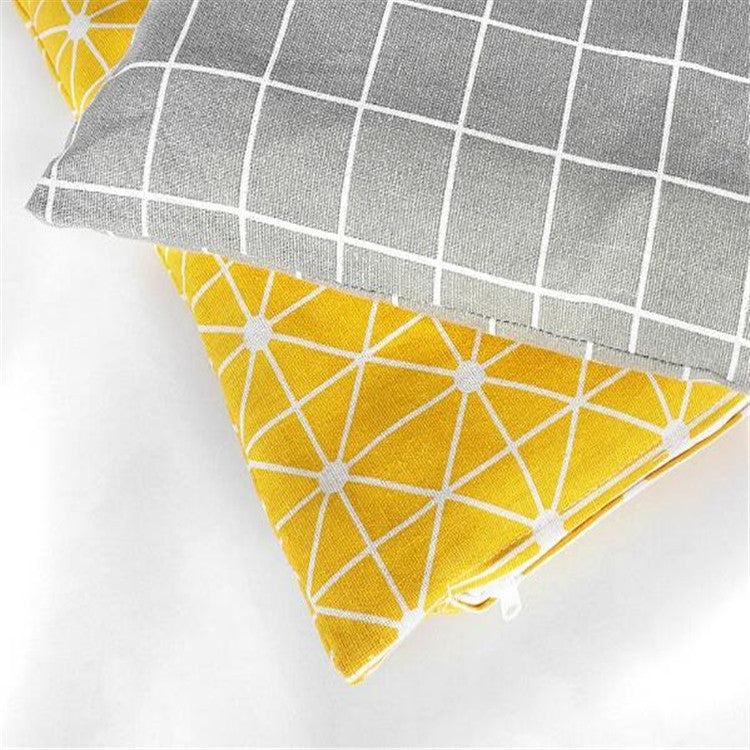 Corner close-up of gray grid and yellow geometric pet sleeping mat