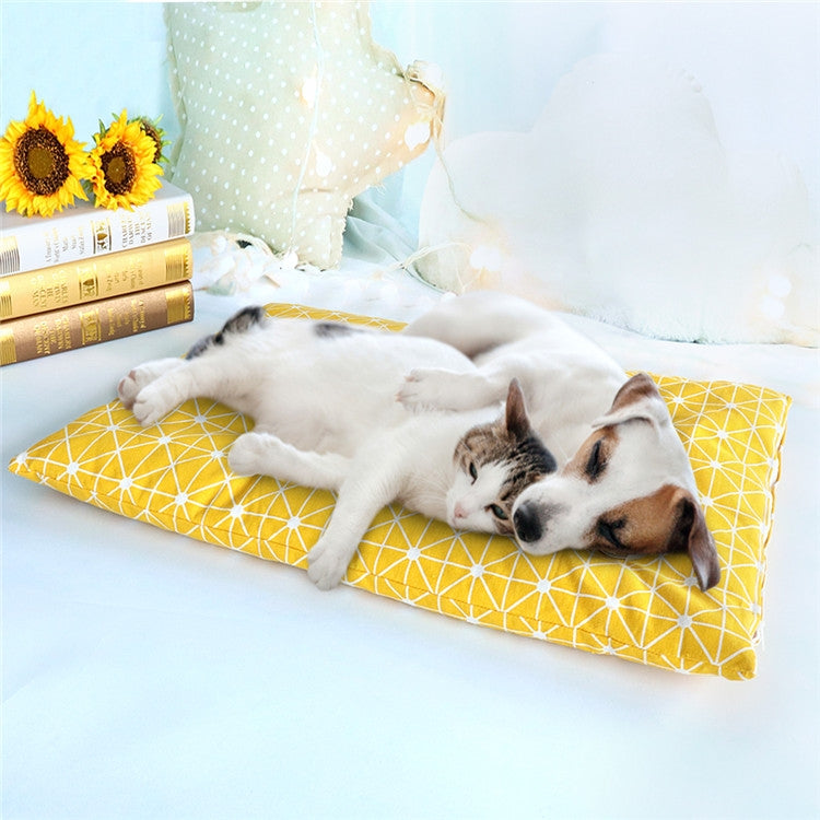 Yellow geometric pet sleeping mat with white dog resting on front legs