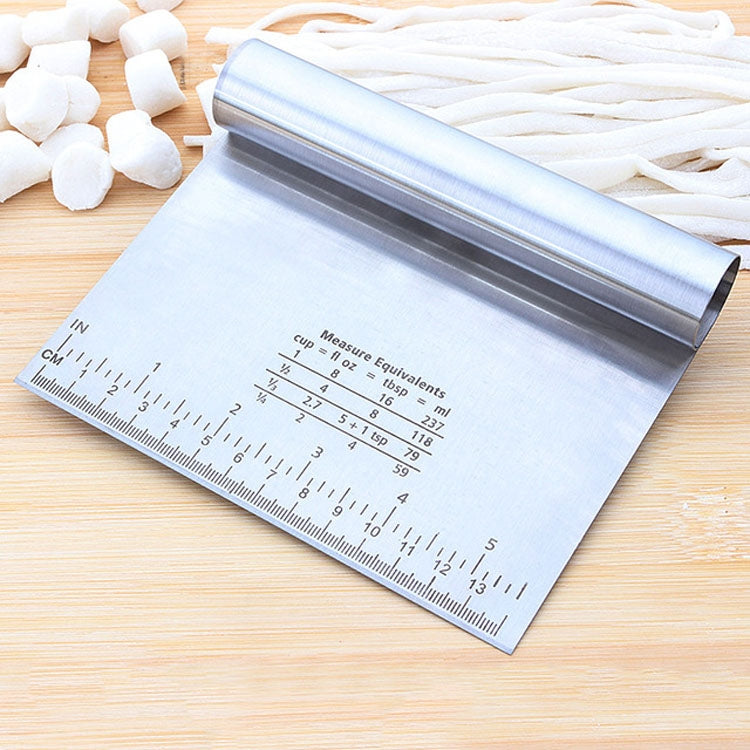 Stainless steel noodle cutter with measuring scale on flat base mat