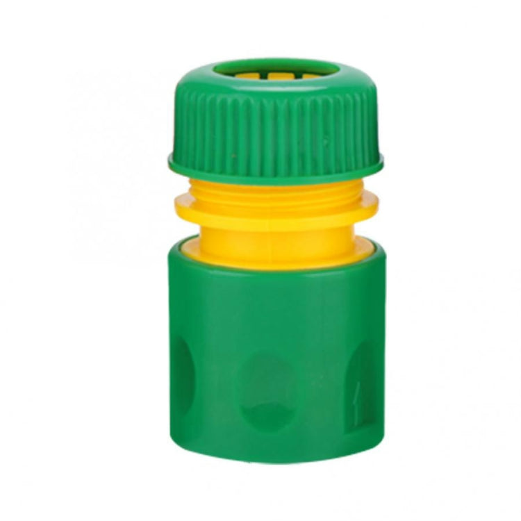 Green garden water connection joint with yellow quick-connect ring and ridged top cap