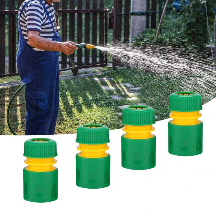 Multiple green garden water connection joints with yellow quick-connect rings and blue spray hose