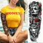 Large arm sleeve temporary tattoo sticker with grayscale surreal face, red rose accents, and flowers.