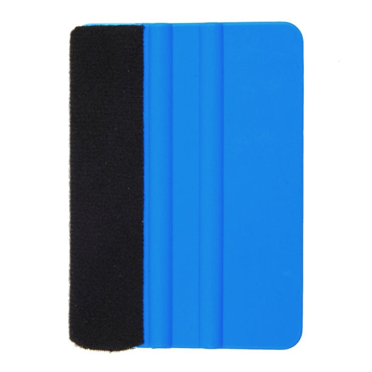 Blue plastic scraper with black felt pad, close side view of cleaning tool