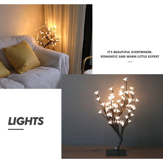 Warm white LED light tree silhouette on black stand, flowering branch tips