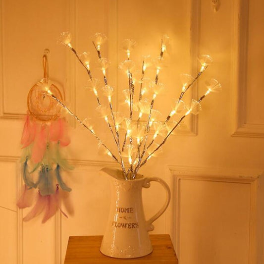 LED flower twig light string with white blossoms in a cream pitcher vase