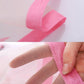Pink anti-insect mesh curtain close-up showing fine grid and rolled edge