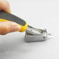 Hand holds nail remover tool showing metal spring head and black grip pad