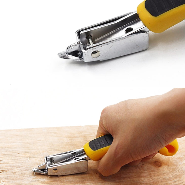 Nail remover tool with yellow handle clamped onto a wooden board