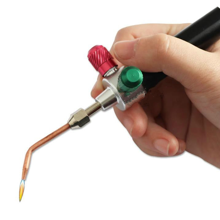 Handheld punching tool head with green and red knobs and copper nozzle