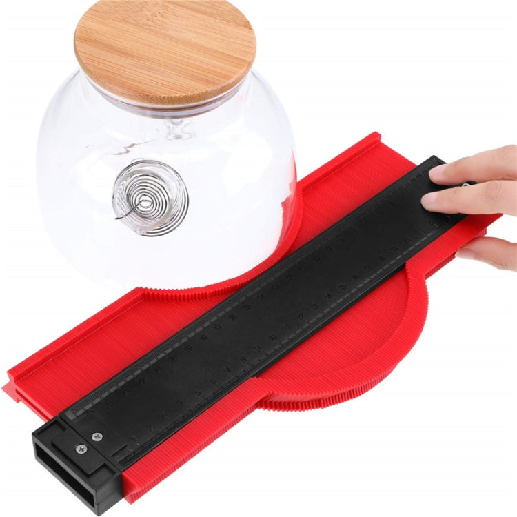 Red irregular contour gauge tool with black ruler and adjustable pointer