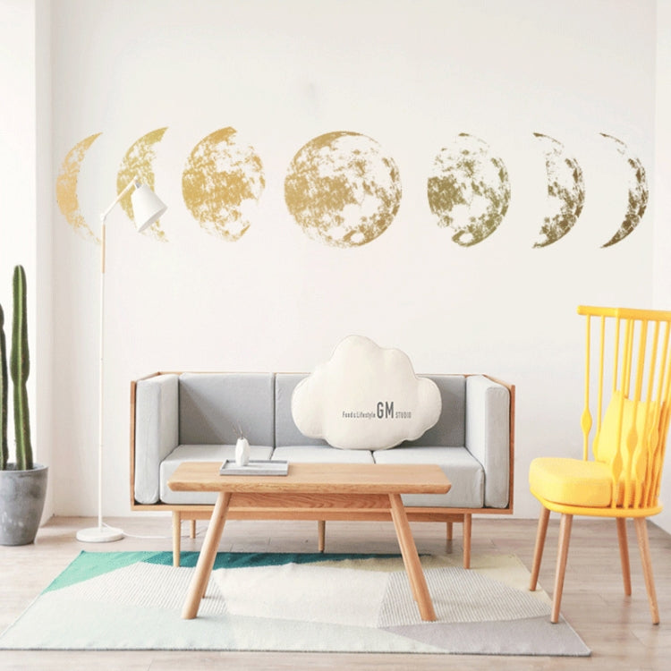 Gold moon phase wall stickers with cratered crescents and partial full moons in a line.