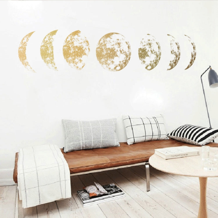 Gold moon phase wall decals with cratered crescents and partial moons across the wall.