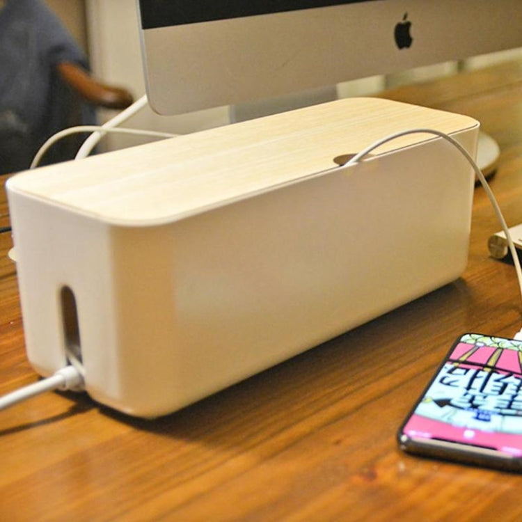 White power cable storage box with wood-look lid and connected charging cords