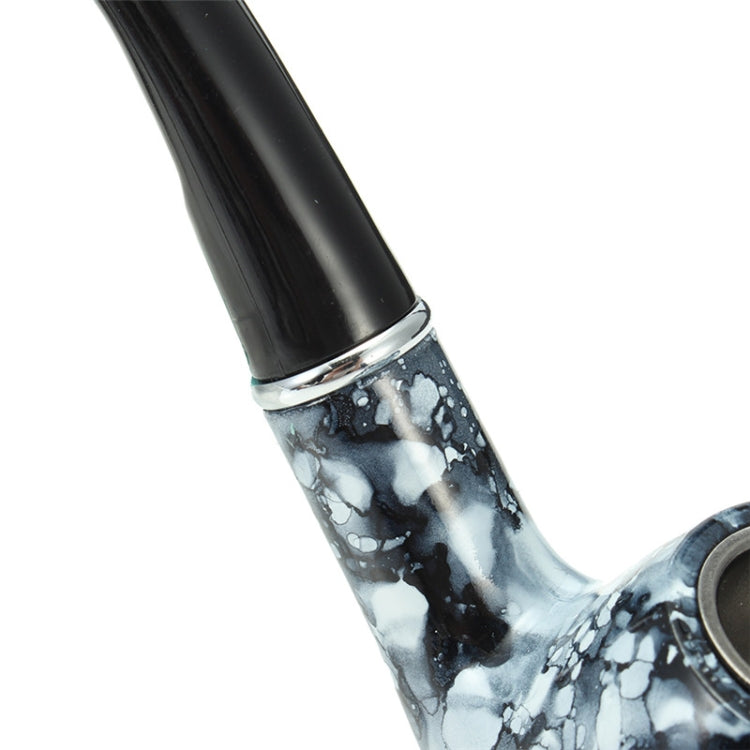 Metal smoking pipe close-up of black stem and marble-pattern bowl junction