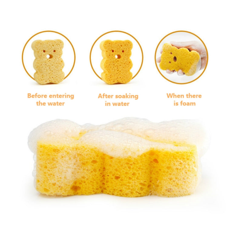 Yellow duck bath sponge bundle soaked in water, expanded soft foam texture