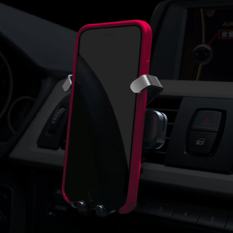 Car air vent phone holder with red frame holding a smartphone
