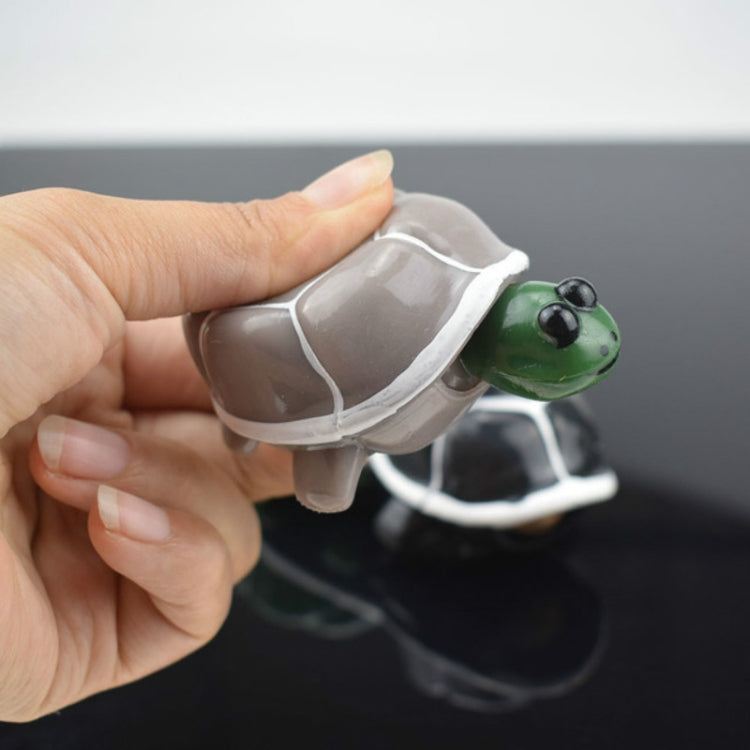 Telescopic turtle squeeze toy, gray shell with green face visible as it extends