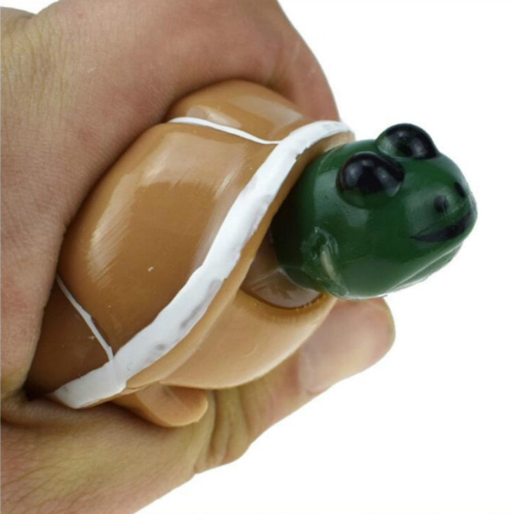 Telescopic turtle squeeze toy with tan shell and green head, close-up in hand