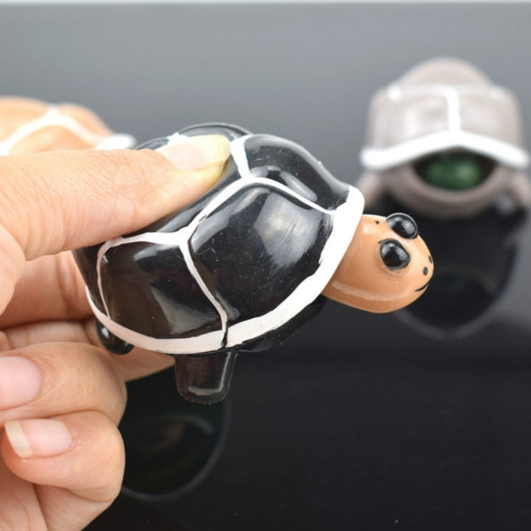 Telescopic turtle squeeze toy with black-and-white shell and orange head peeking out
