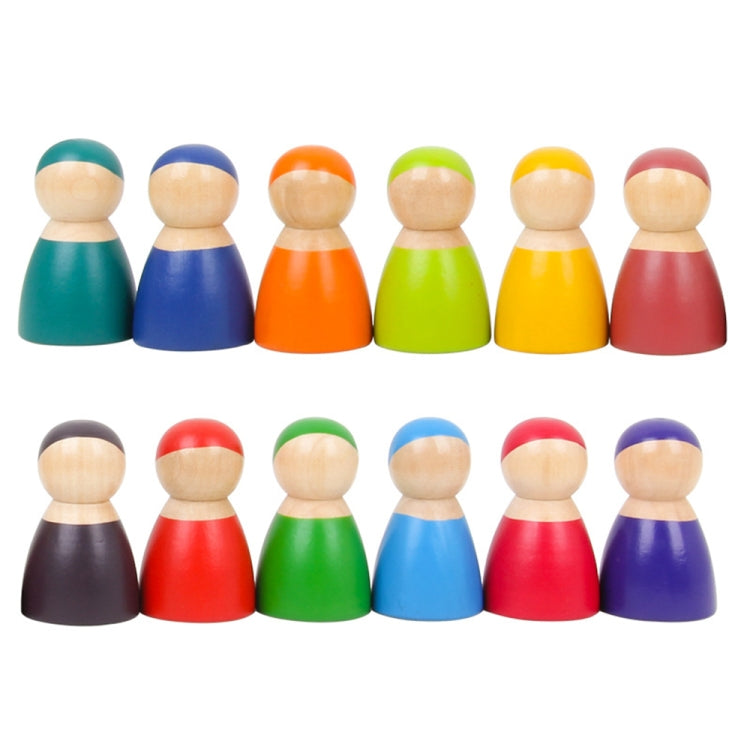 12 rainbow wooden peg dolls arranged in two rows, round heads and painted bodies