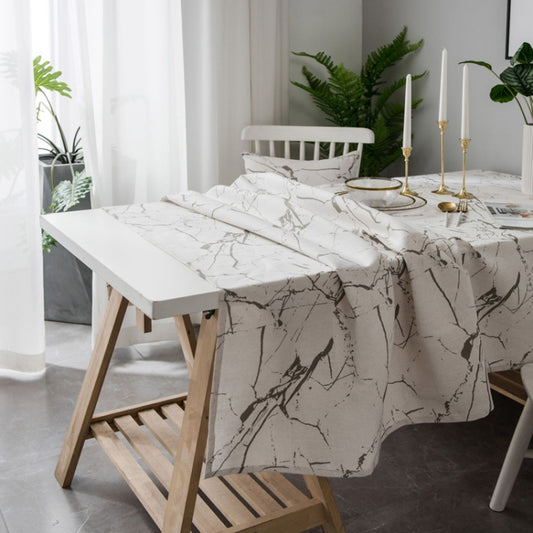 White marble-pattern tablecloth with black veining, draped over a dining table edge