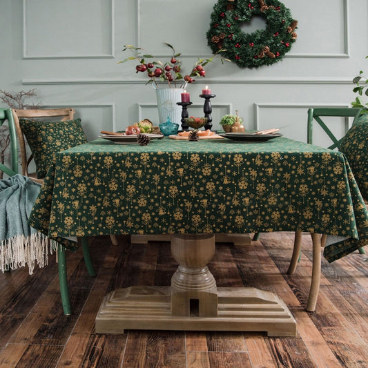 Green rectangular Christmas tablecloth with gold motif pattern across the table