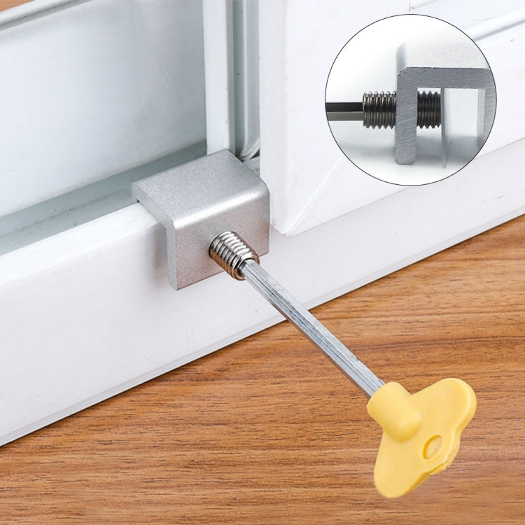 Anti-theft door/window stopper with metal bracket and yellow key, installed on window frame