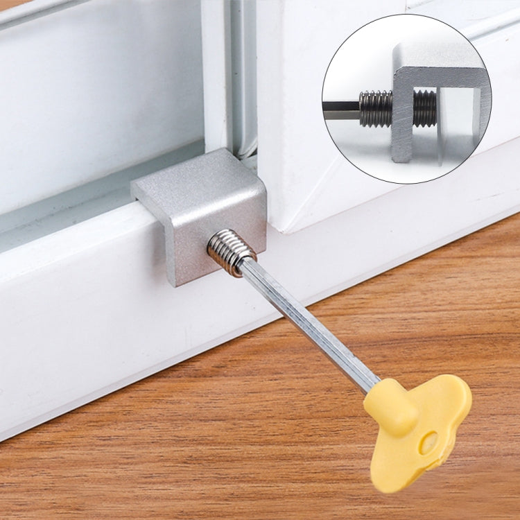 Anti-theft door/window stopper kit showing metal bracket and yellow key on window frame