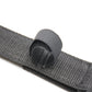 Gray fabric strap end pad with textured surface and hook-and-loop underside