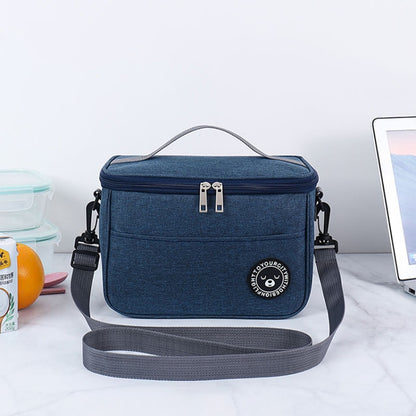 Blue thermal lunch cooler bag with top handle, zipper closure, and front logo patch