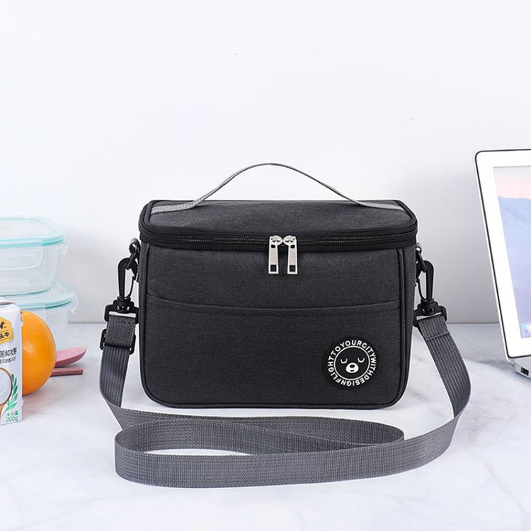 Black thermal lunch cooler bag with top handle and shoulder strap, zipper closure, logo patch