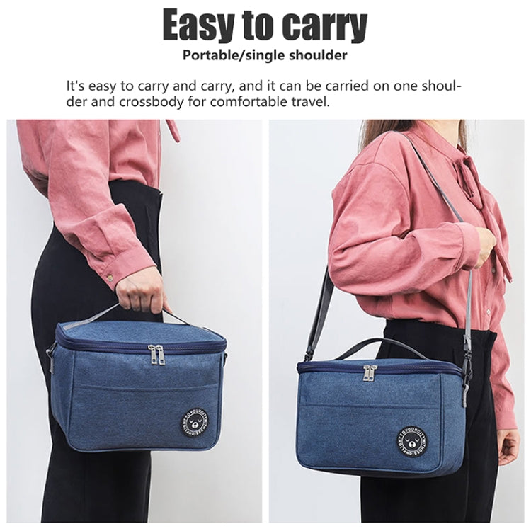 Blue insulated lunch cooler bag carried crossbody and on one shoulder, front zipper and strap