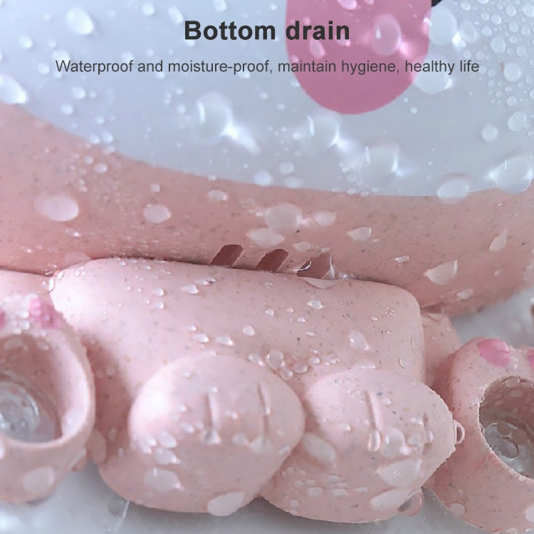Pink waterproof toothbrush holder base with droplets and drainage opening.