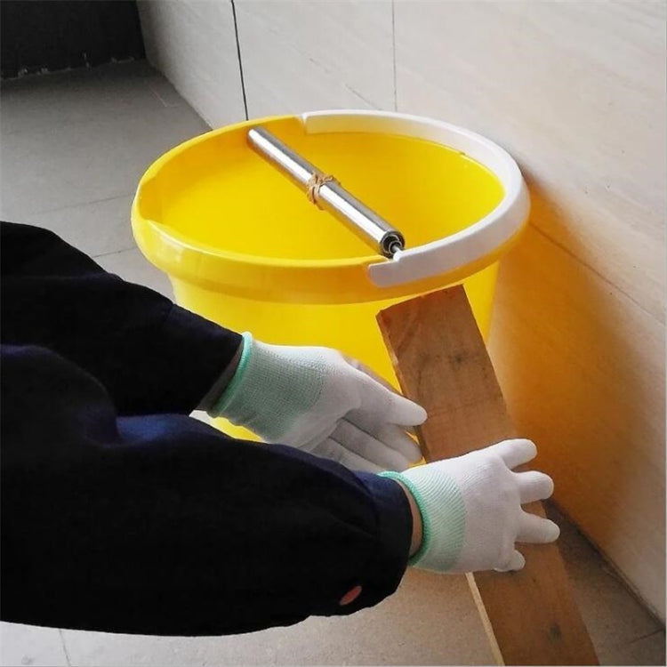 Automatic continuous mousetrap loaded on a yellow bucket near a wooden floor