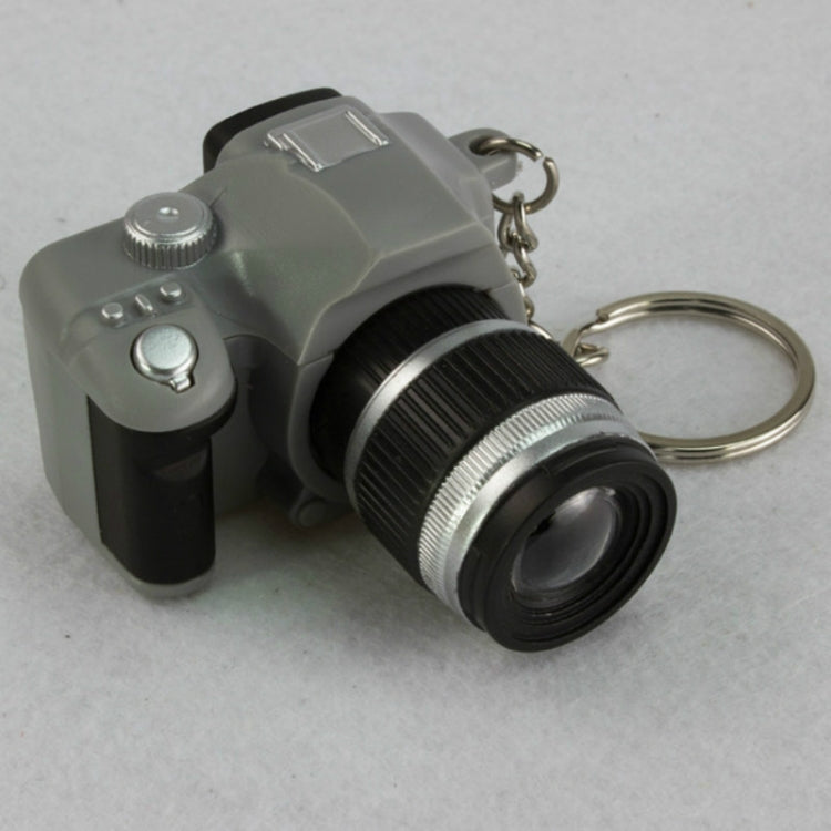 Gray mini SLR camera keychain pendant, front view with strap ring