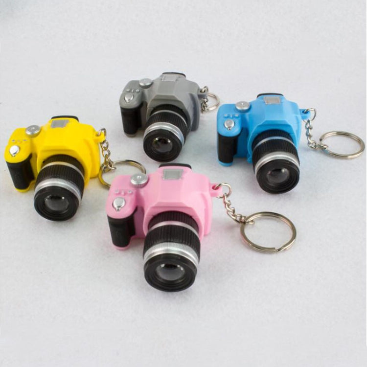 Set of four mini SLR camera keychain pendants in yellow, gray, blue, and pink