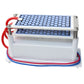 Portable ceramic ozone generator with dual hex ceramic panels and red cable loop, angled view