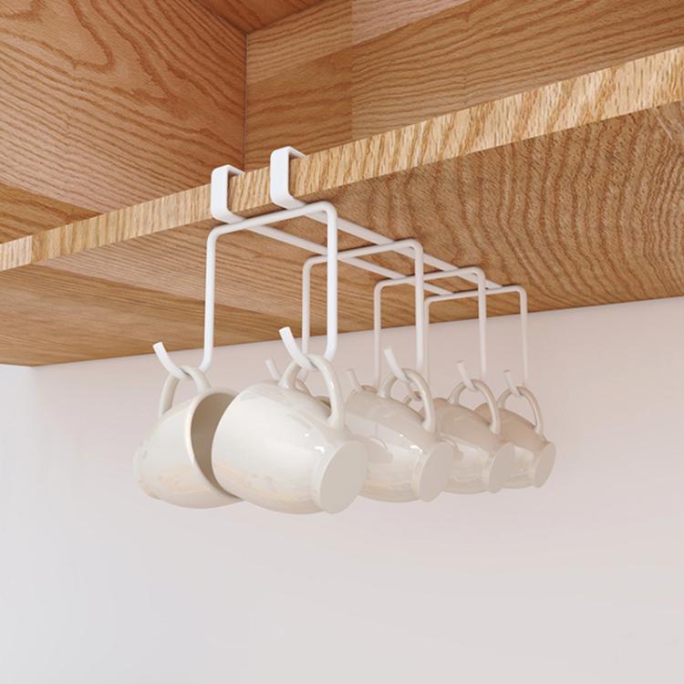 White hanging cup holder rack under shelf, holding several upside-down cups