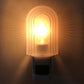 Lit LED night light with translucent arched cover and blue base switch