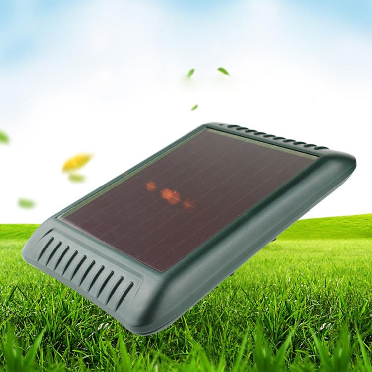 Solar panel top on green outdoor ultrasonic animal repeller