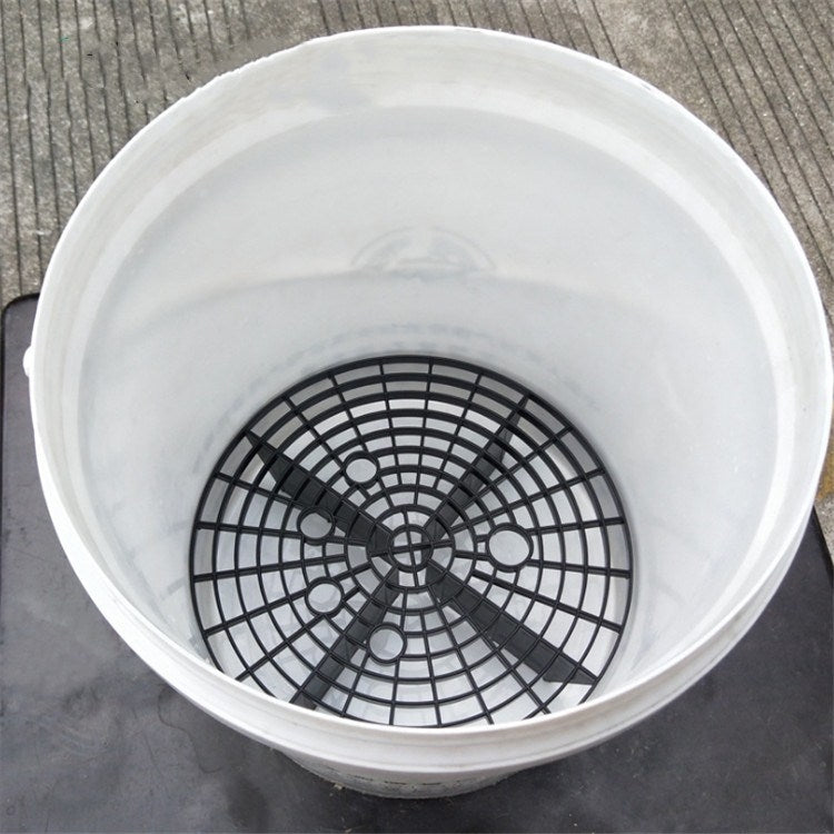 White bucket with black circular sand-filter net insert, grid pattern and center ring