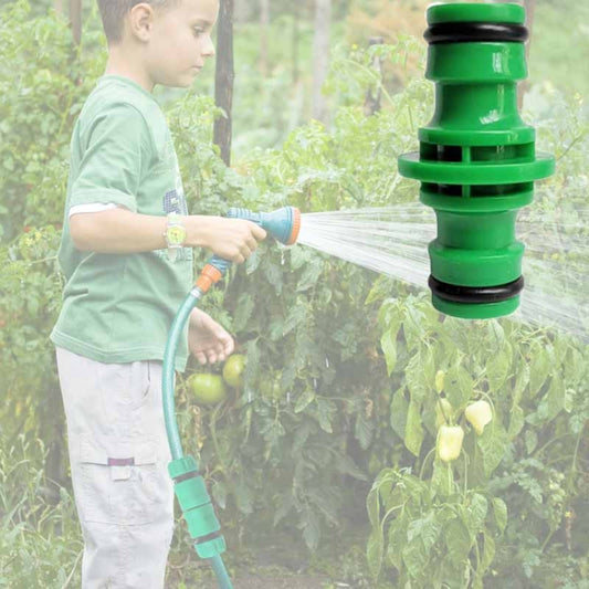 Green plastic two-way hose repair extension with quick connector on a garden hose
