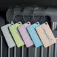 Set of brush aluminum luggage tags in green, purple, blue, and tan with airplane cutouts