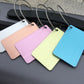 Pastel brush aluminum luggage tags in pink, lime, and blue with airplane cutouts