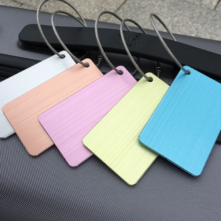 Pastel brush aluminum luggage tags in pink, lime, and blue with airplane cutouts