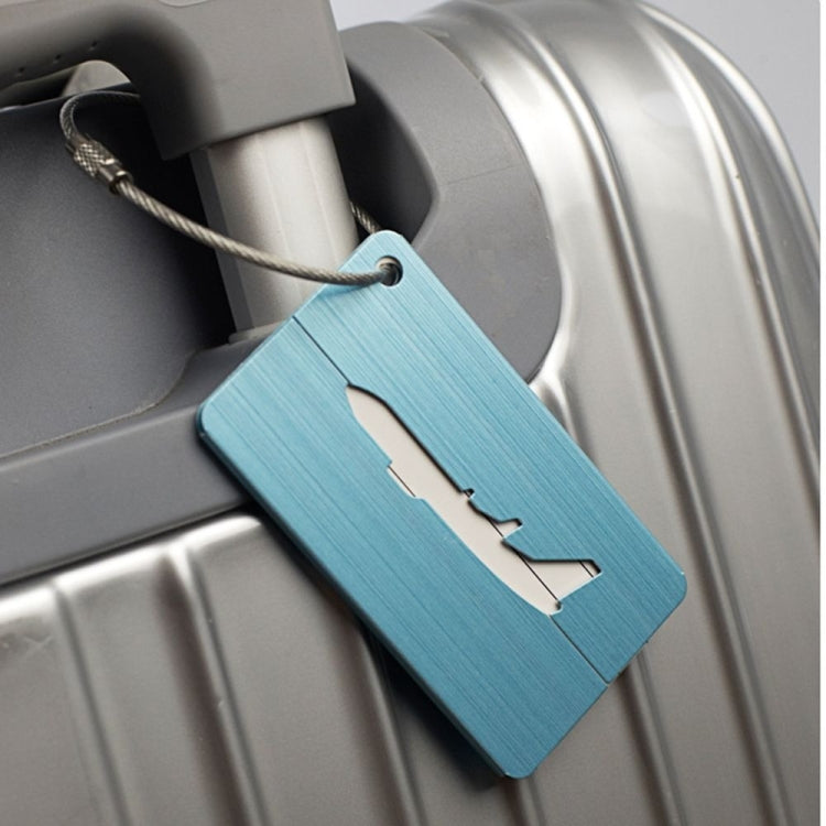 Blue brush aluminum luggage tag with airplane cutout and braided rope loop on suitcase