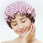 Waterproof shower hair cap worn, light pink with dark purple polka dots and ruffled trim