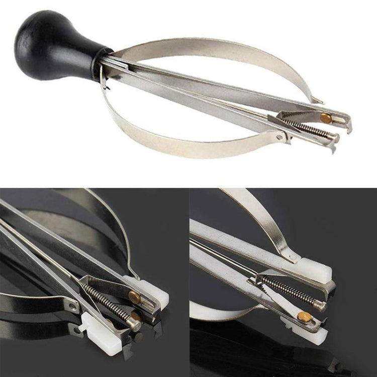 Watch pointer remover clamp tool close-up showing spring mechanism and black base