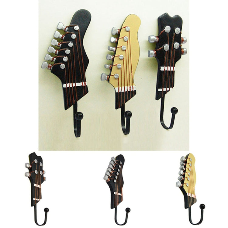Set of three guitar-head wall hooks in black, light yellow, and dark, each with curved iron hook