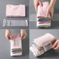 Hands fastening self-adhesive straps around folded shirts and fabric stacks